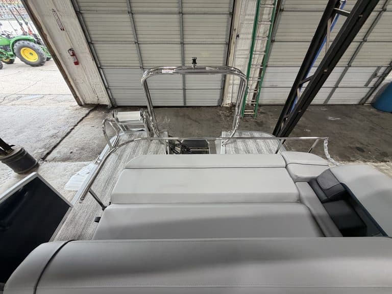 Bennington 23 SSB pontoon boat inside Hall's Sport Center.