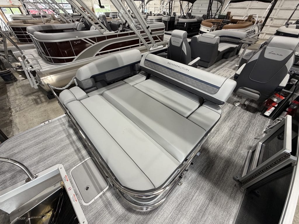 Bennington 23 SSB pontoon boat with seating and steering console.