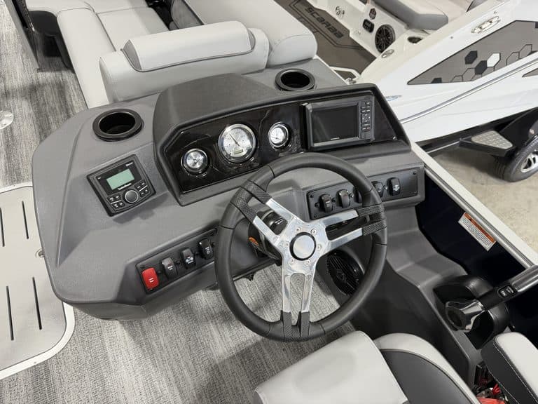 Close-up of boat dashboard with steering wheel and controls at Hall's Sport Center.