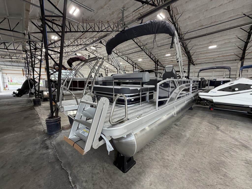 Bennington 23 SSB pontoon boat inside Hall's Sport Center.