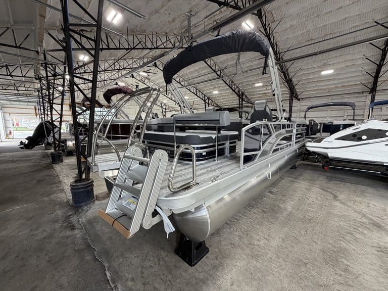 Bennington 23 SSB pontoon boat inside Hall's Sport Center.