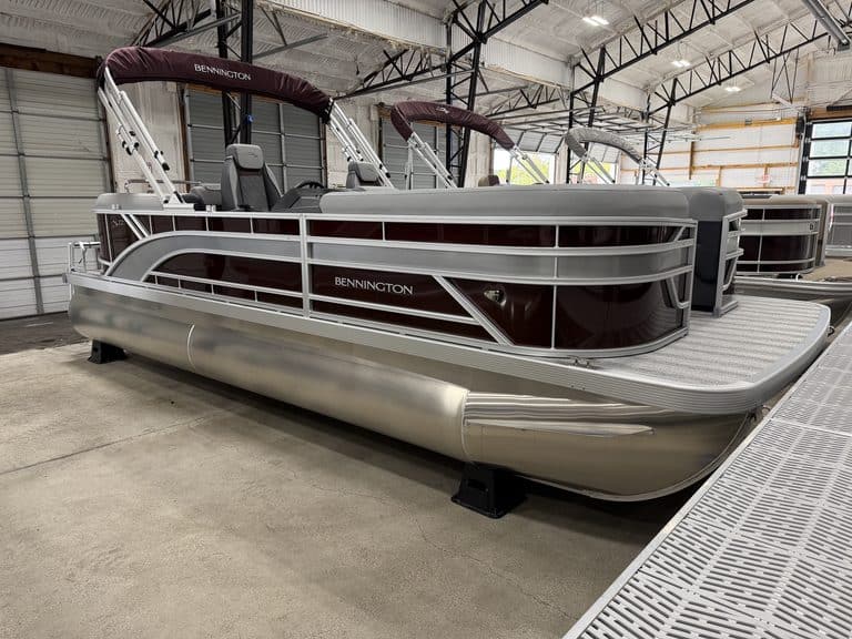 Bennington 22 SSR pontoon boat inside a showroom with a metal roof.