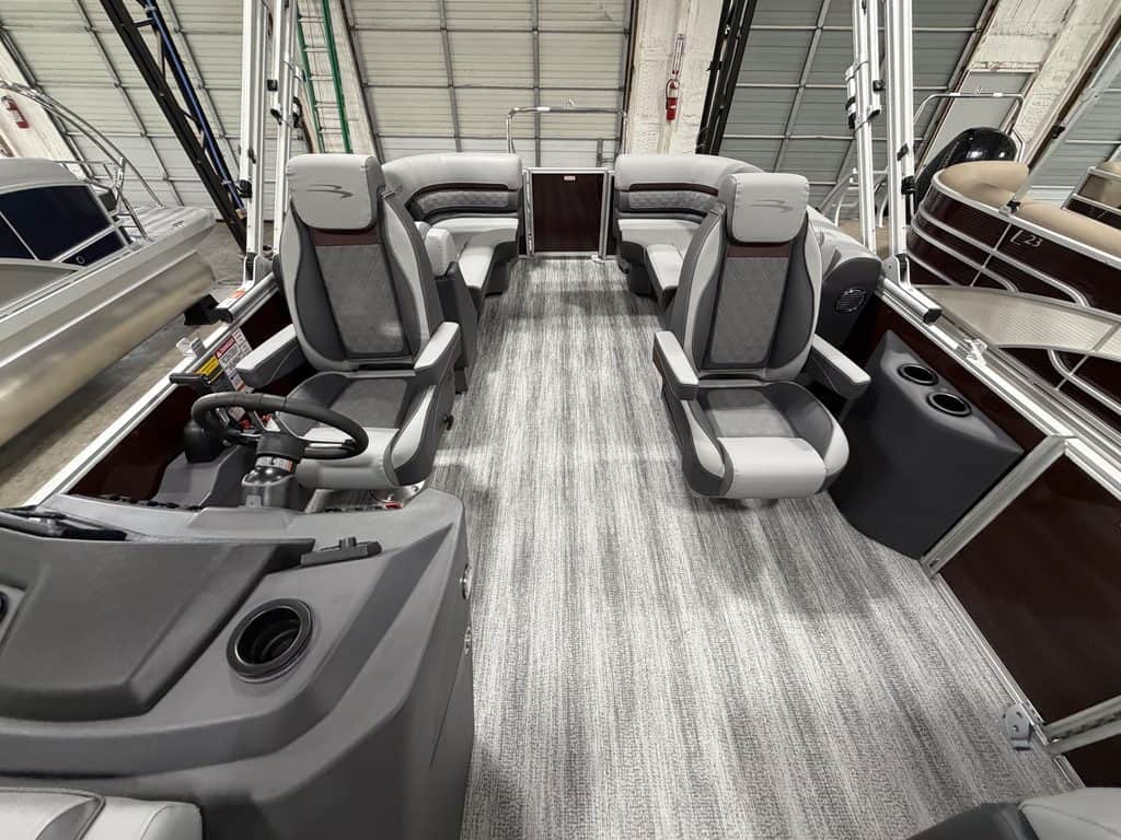Interior view of a Bennington 22 SSR pontoon boat with seating and steering area.