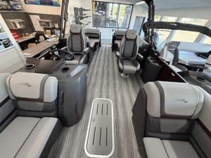 Luxury boat interior with seating and steering area at Hall's Sport Center.