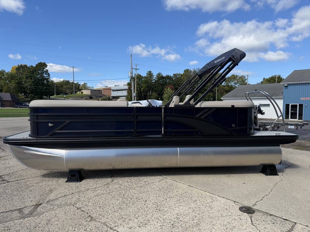 Bennington 21 SSR pontoon boat with black and silver design on a paved lot.