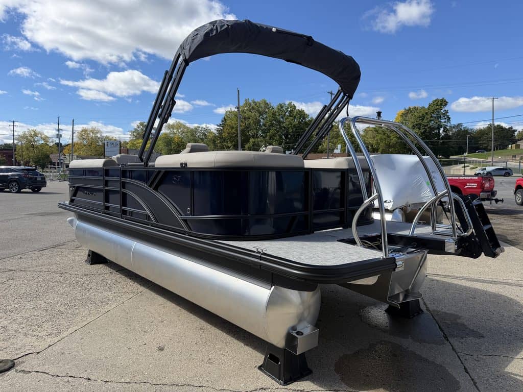 Bennington 21 SSR pontoon boat with canopy on display at dealership.