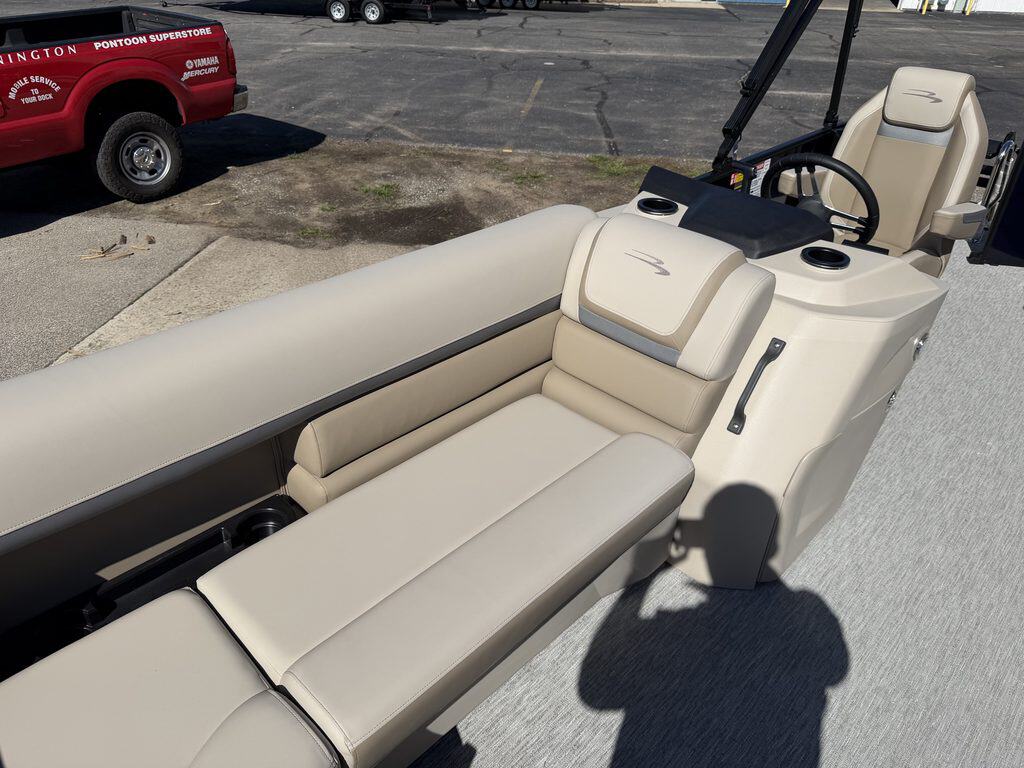 Luxury Bennington 20 SL pontoon boat with beige upholstery and steering console.