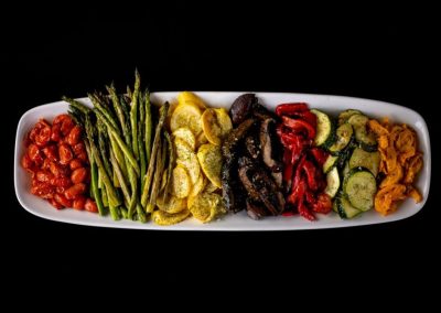 Assorted grilled vegetables on a white platter for healthy diet.
