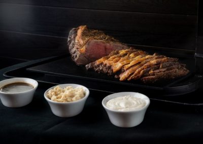Juicy slow-cooked ribs with three dipping sauces and mashed potatoes.