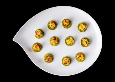 Colorful Indian sweets arranged on a white plate for celebration.