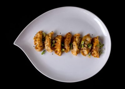 Delicious sushi rolls garnished with green herbs on a white plate.
