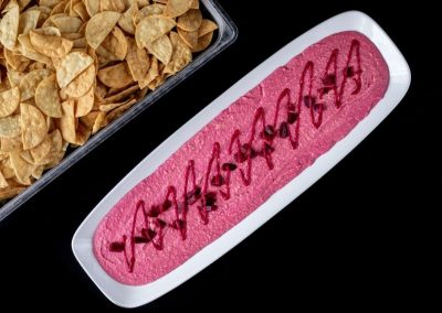 Colorful snack platter with pink dip and chips for parties.