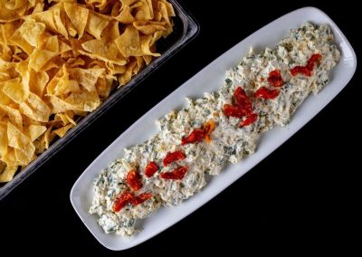 Chicken salad with ketchup spelling 'LISA' on white plate.