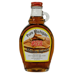 Pure Michigan maple syrup in a glass bottle with red cap.