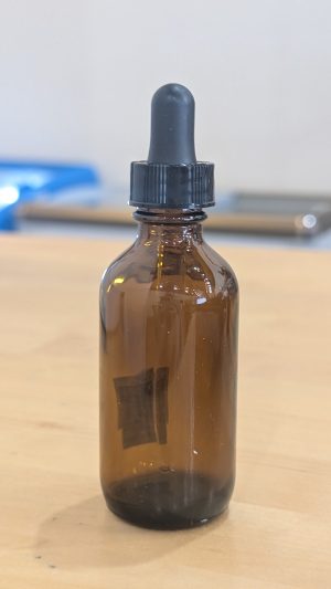 2oz amber glass dropper bottle for essential oils or serums.