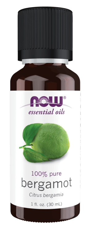 Bergamot essential oil bottle with green bergamot fruit and leaf.