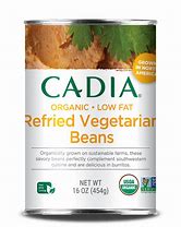 Cans of Cadia Organic Low Fat Refried Vegetarian Beans on a white background.