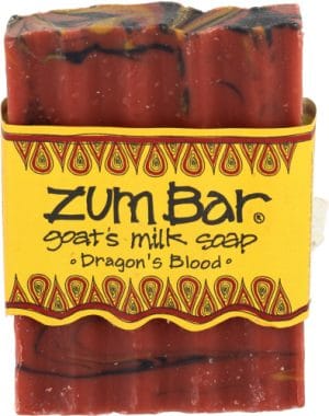 Handcrafted goat milk soap with dragon's blood, vibrant red color, and decorative design.
