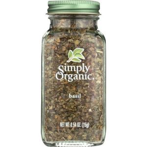 Organic basil spice in glass jar for healthy cooking and herbal remedies.