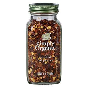 Organic crushed red pepper in glass jar for cooking and seasoning.