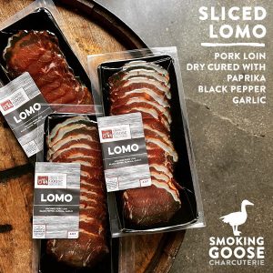 Sliced lomo pork from Smoking Goose charcuterie, seasoned with paprika, black pepper, and garlic.