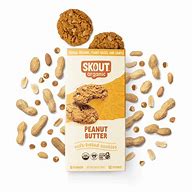 Peanut butter cookie with peanuts and cookie crumbs on a white background.