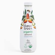 Three Trees organic almond milk bottle with floral design and label details.