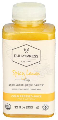 Cold pressed spicy lemon juice with apple, lemon, ginger, turmeric in a bottle.
