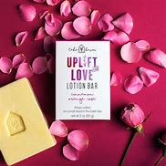 Healthy Roots Lotion Bar with pink flower petals for skin care.