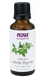 Pure white thyme essential oil in a small amber bottle with a white label.