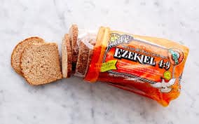 Healthy Ezekiel 4:9 sprouted grain bread on a white surface.