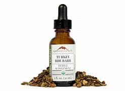 Turkey Rhubarb extract in a dropper bottle with dried rhubarb roots.