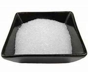 Epsom salt in a black dish for health and relaxation.