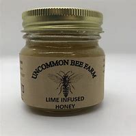 Lemon infused honey jar from Uncommon Bee Family on a white background.