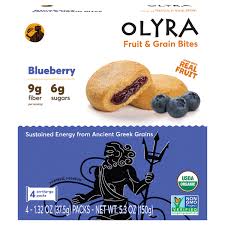 Healthy blueberry fruit and grain bites with fresh blueberries on packaging.