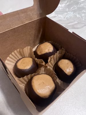 Vegan chocolate peanut butter cups in a box with paper liners.
