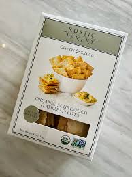 Organic sourdough flatbread bites in a white box with Rustic Bakery label.