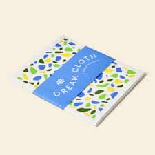 Dream Cloths packaging with colorful leaf pattern and blue label.