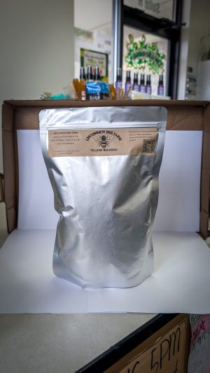 Beeswax pellets in silver bag for natural skincare and candle making.