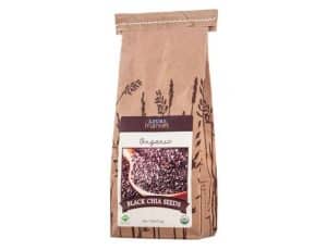 Organic black chia seeds in a brown paper bag for healthy eating.