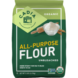 Organic all-purpose flour in green packaging with baking ingredients.