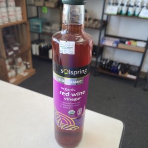 Healthy Roots organic red wine vinegar bottle on store shelf.