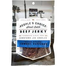 Cowboy Peppered Beef Jerky in clear packaging with beach background.