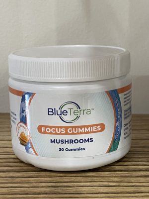 Blue Terra Focus Mushrooms Gummies container on wooden surface.