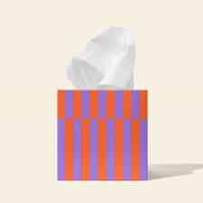 Bamboo facial tissue box with tissue emerging, eco-friendly product.