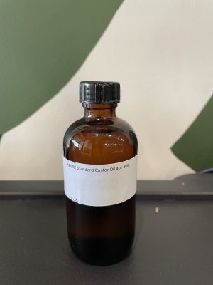 Amber glass bottle of Azure Standard Castor Oil 4oz with label.