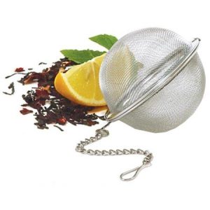 Stainless steel mesh tea ball with lemon and tea leaves for brewing.