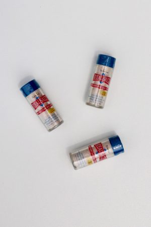Three Realsalt sea salt pocket shakers on white background.