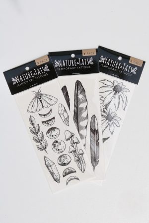 Assorted nature-themed temporary tattoos including feathers, moons, leaves, and insects.