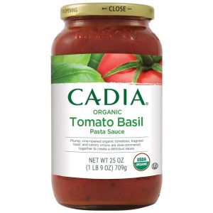 Organic tomato basil pasta sauce jar with fresh tomatoes and basil.